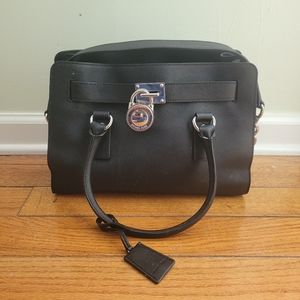 Michael kors purse with lock and key . With storage bag included